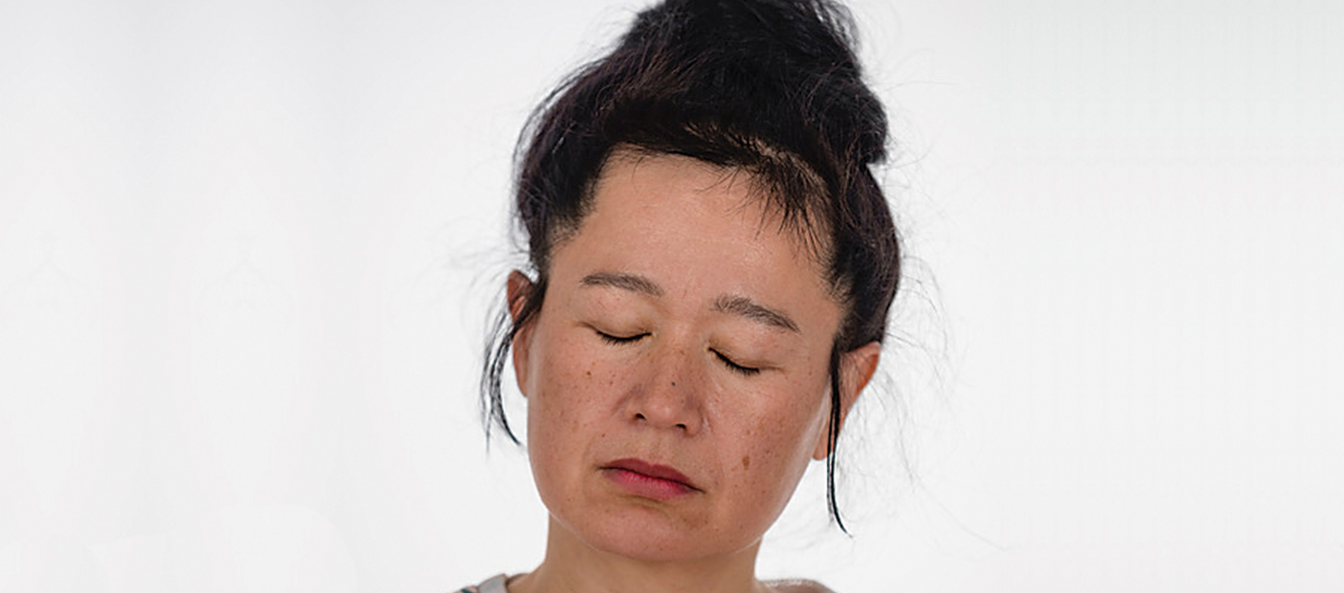 a portrait of Hito Steyerl with eyes closed