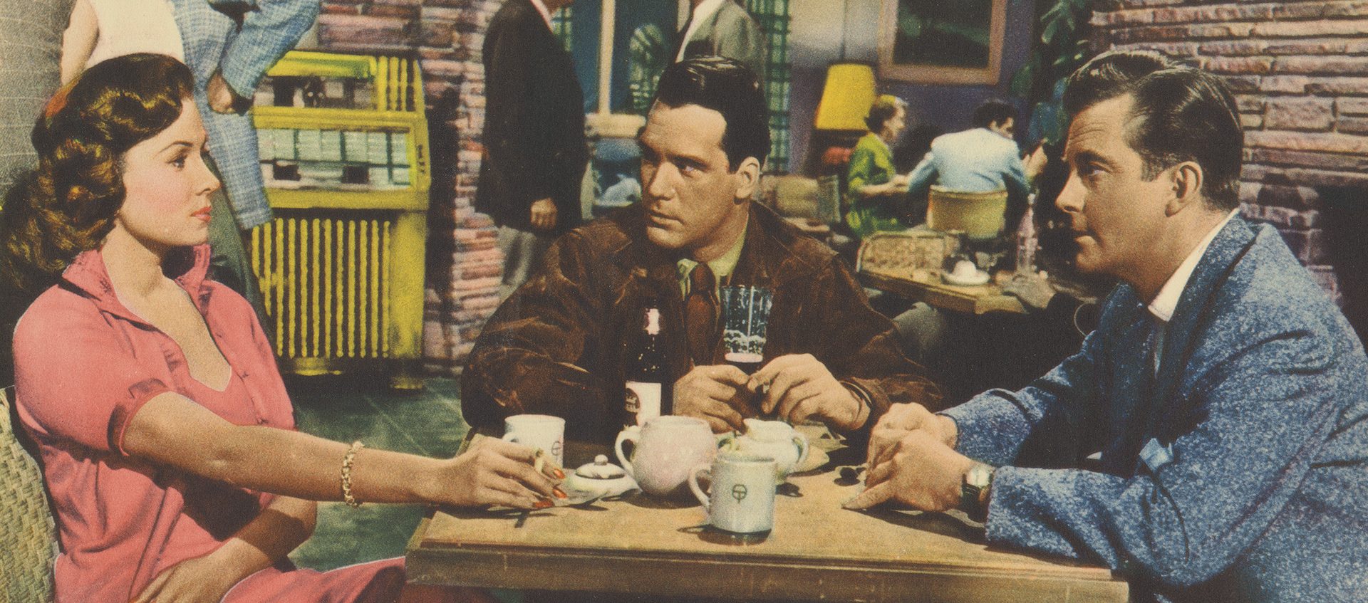 a woman and two men sitted around a table with cigarattes and tea cups