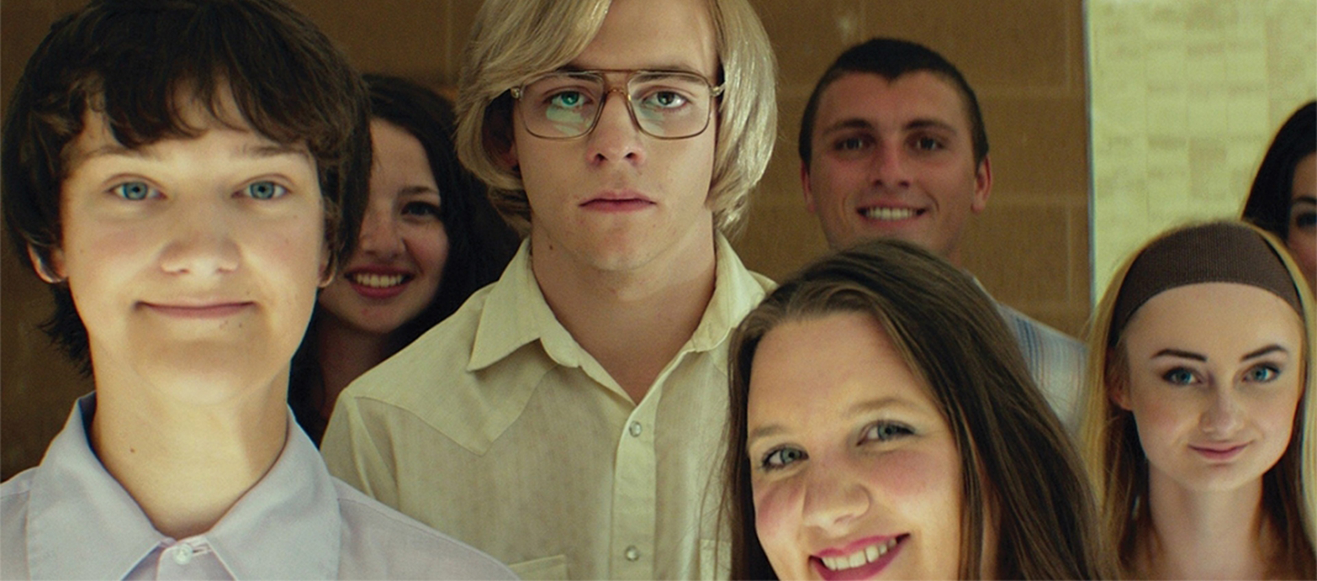 Dahmer and his friends looking into the camera with varying facial expressions
