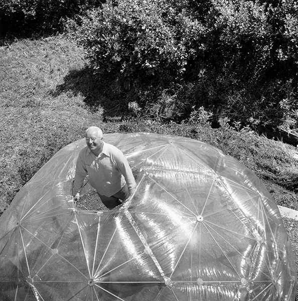 Buckminster Fuller popping out of the top of a geodesic dome