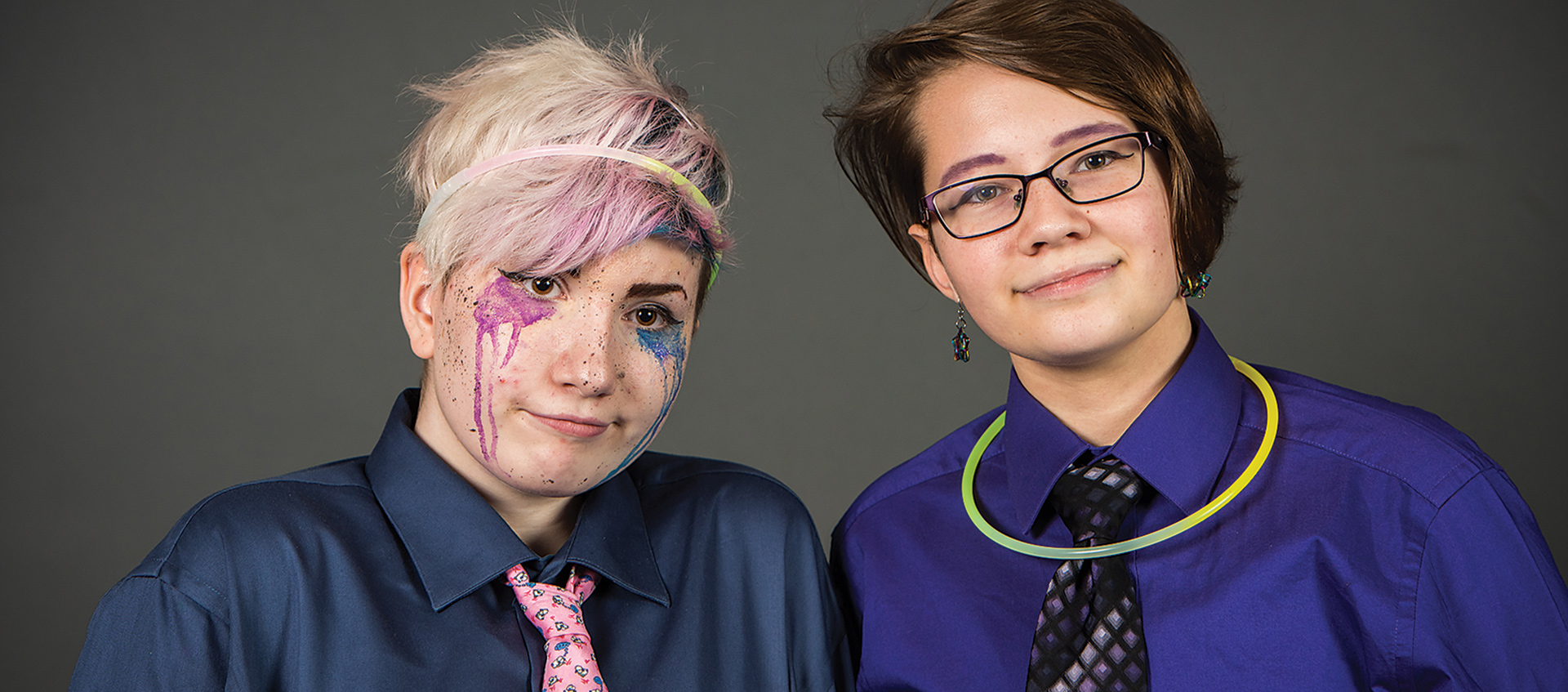 two young person one with glow stick necklace