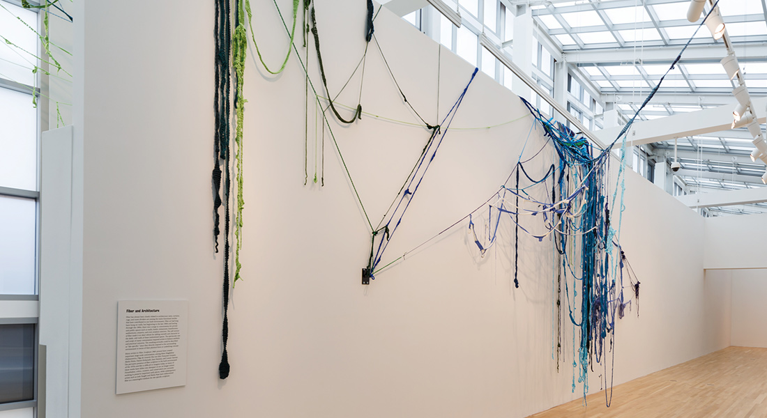 Large textile work spanning an entire wall like a spider web