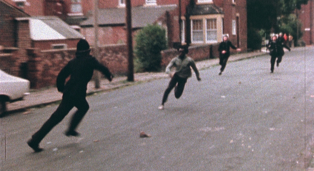 A man chased through the street by three others