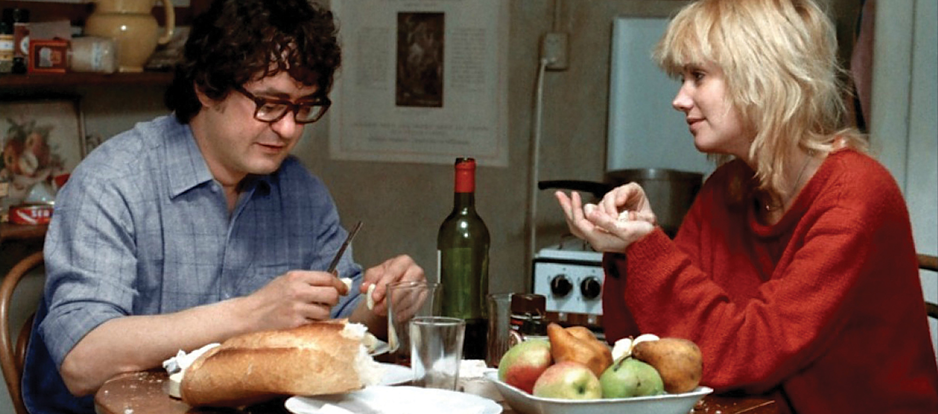 Two people sit at a table eating