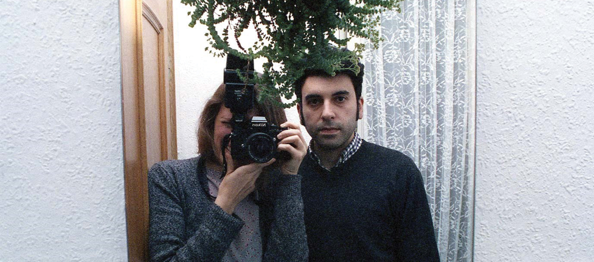 Two people photographed in a mirror