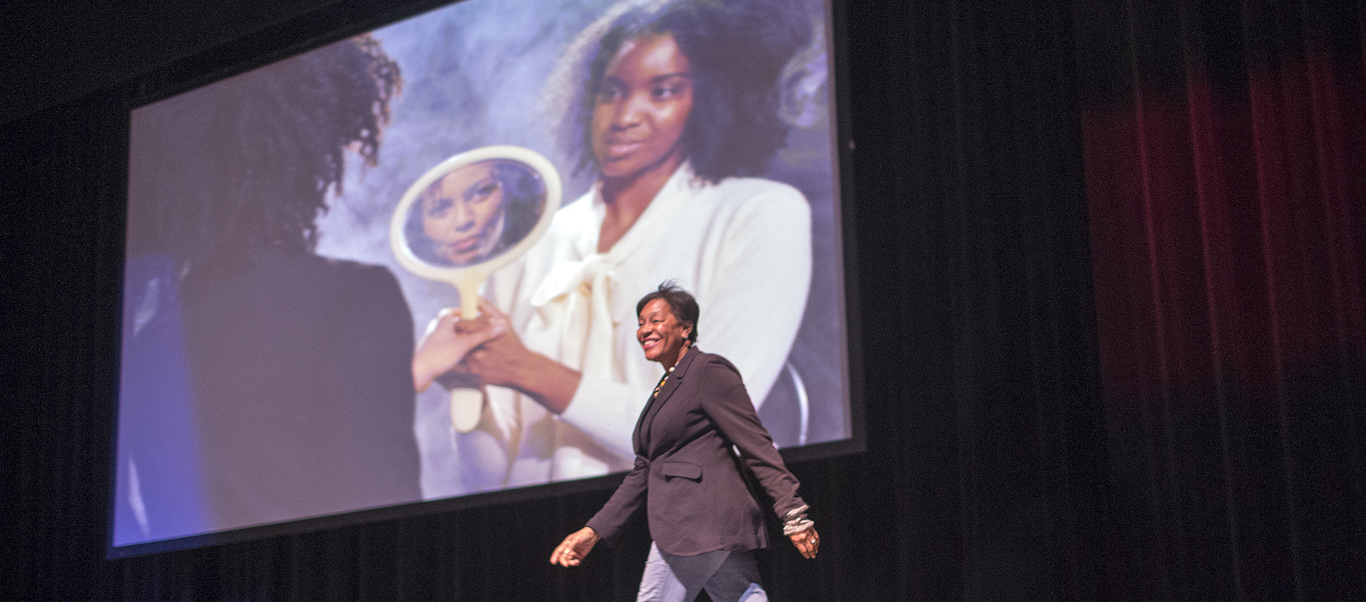 Artist Carrie Mae Weems walks onto the stage at the Wexner Center for the Arts's Mershon Auditorium on Thursday, April 5, 2018