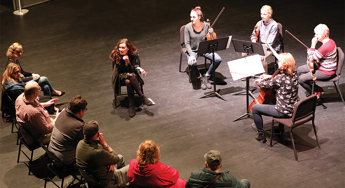 A group of people participate in a music workshop.
