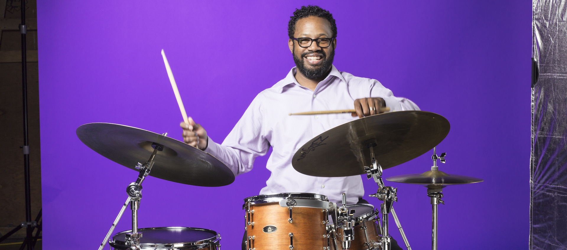 Studio shot of drummer, composer, educator, and activist Mark Lomax II at his drums
