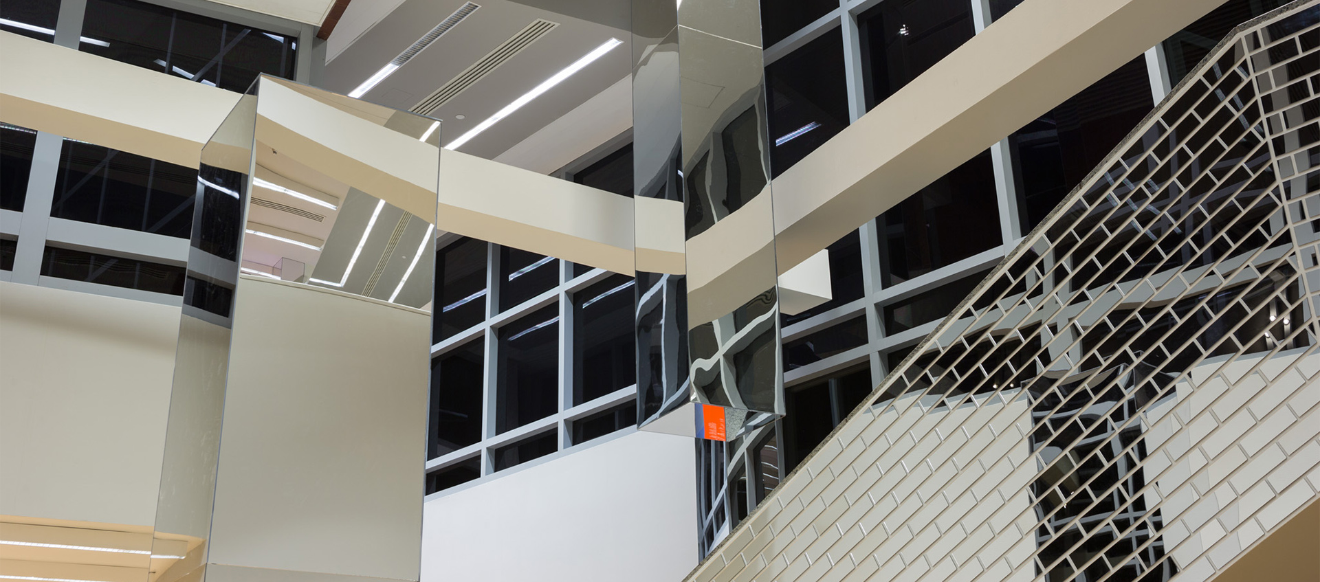 Installation of mirrors on Wex lobby walls and stairs