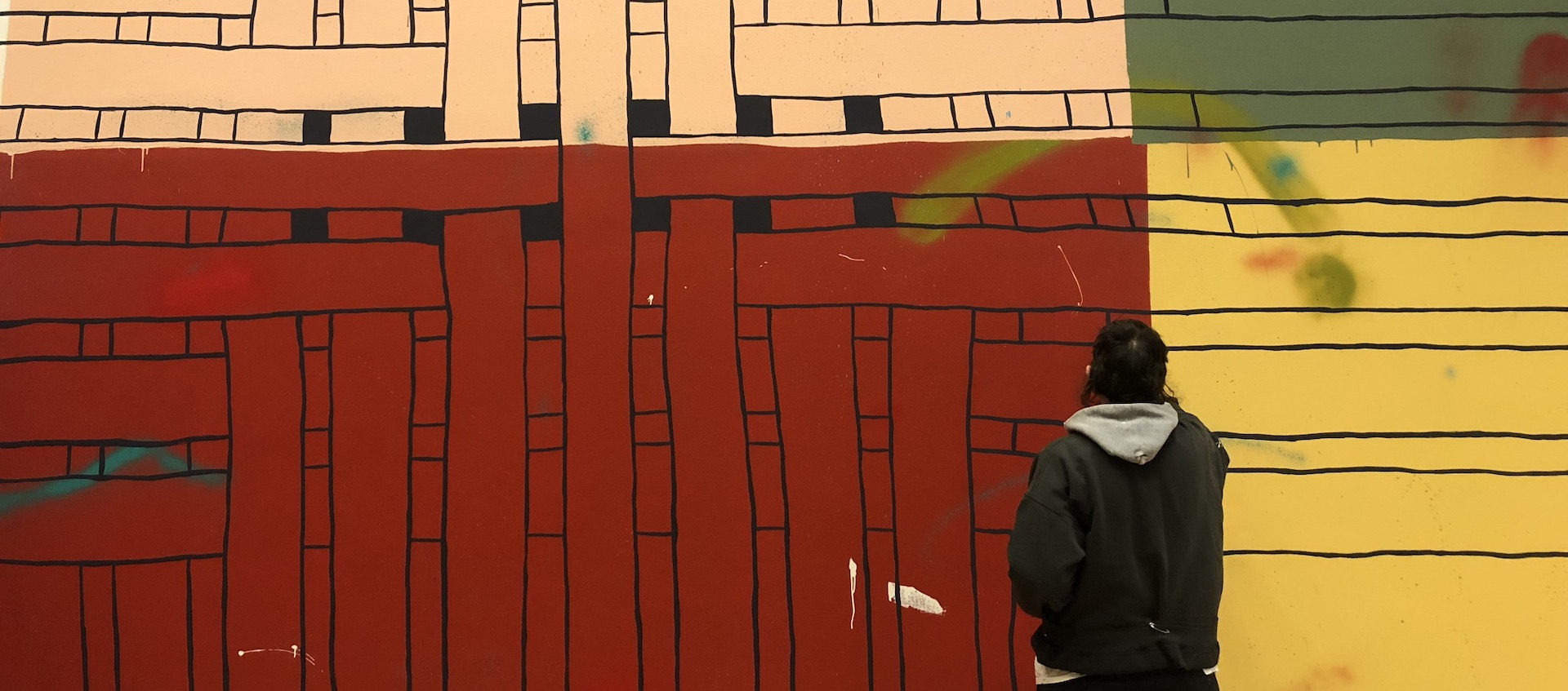 Artists Alicia McCarthy works on the site-specific mural No Straight Lines at the Wexner Center for the Arts at The Ohio State University