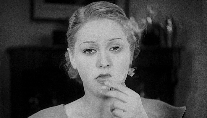A woman smokes a joint in a still from the vintage exploitation film Marihuana: Weed with Roots in Hell