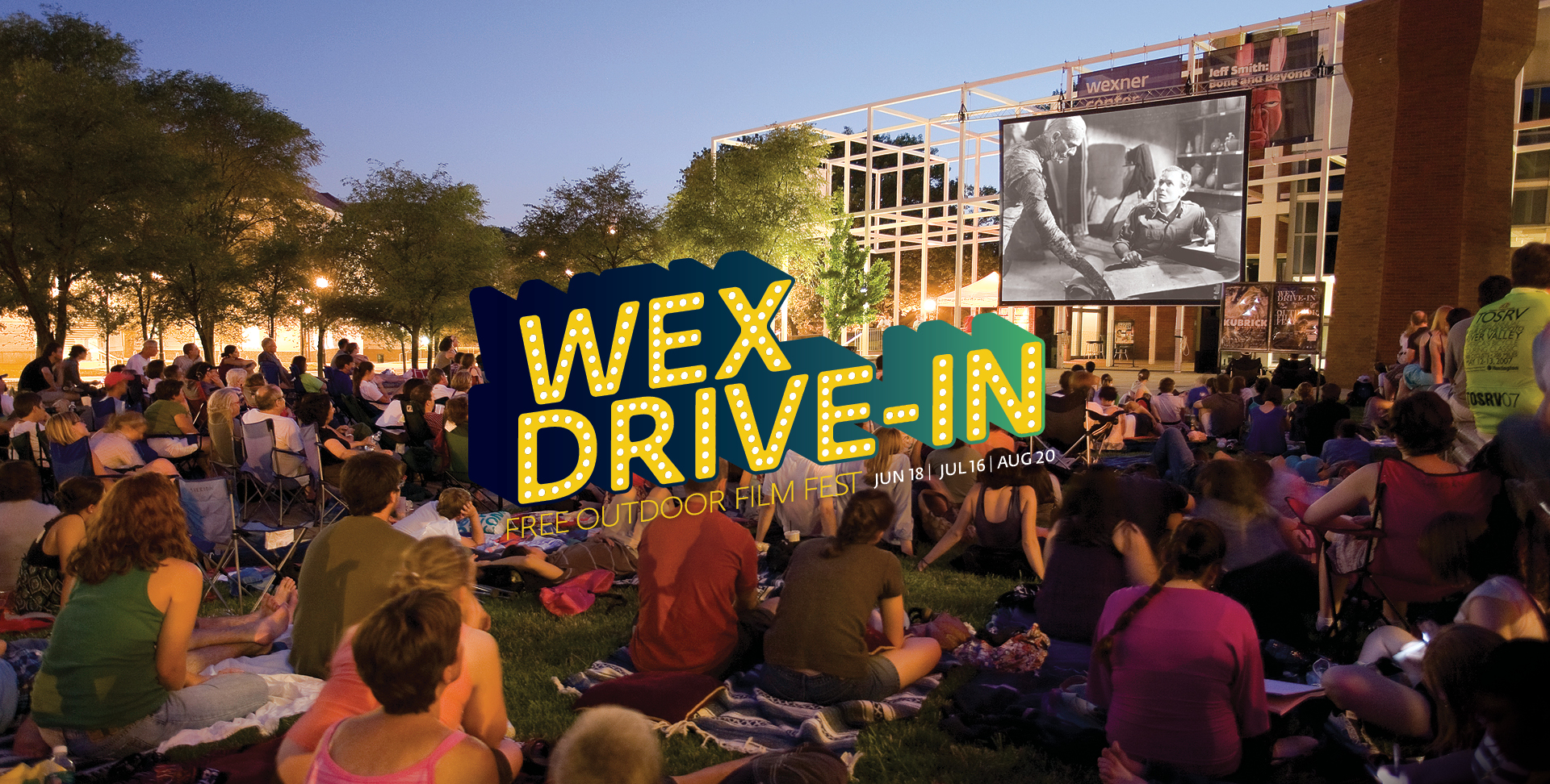 A crowd sits on the Wexner Center plaza enjoying an outdoor movie during the annual film event Wex Drive-In at the Wexner Center for the Arts