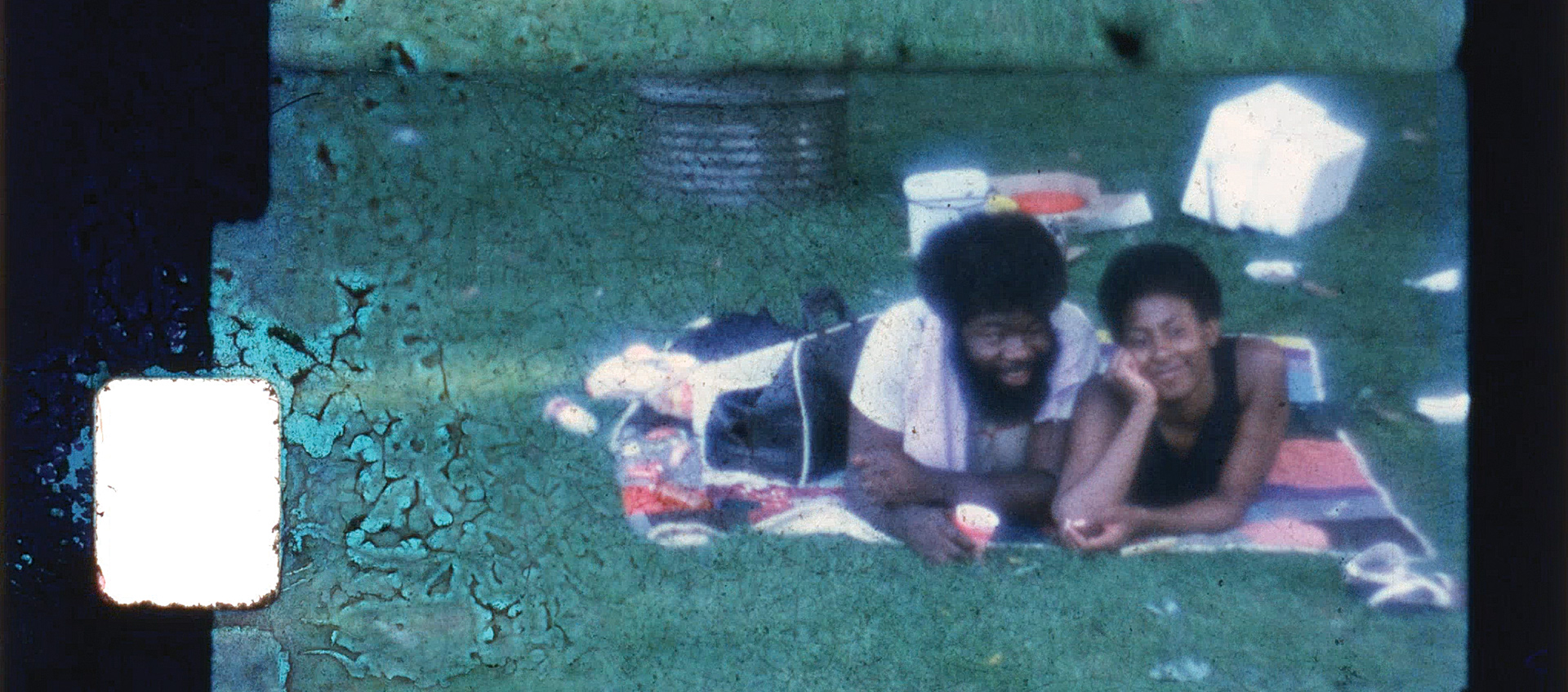 Image of couple laying on a picnic blanket