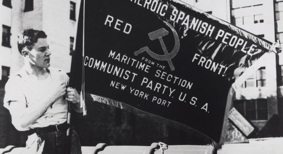 image of a banner carried by two people from Seeing Red: Stories of American Communists