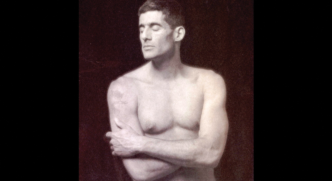 Shirtless man standing with eyes closed