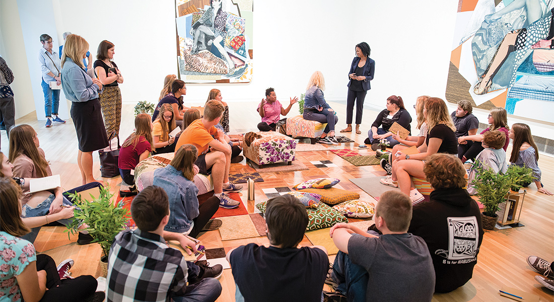 Students sit in a circle in the galleries