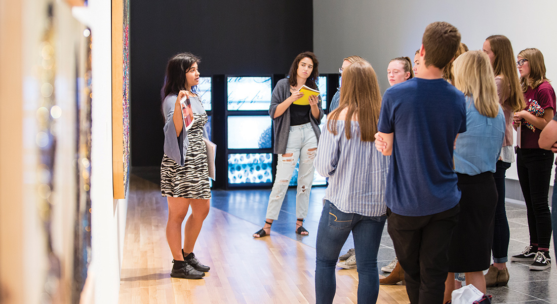 Students standing in a gallery
