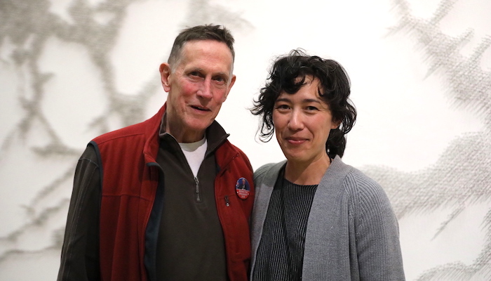 Image from chest up of actor Mark Metcalf and filmmaker Vera Brunner-Sung standing in front of a Pin River wall installation by artist Maya Lin at the Wexner Center for the Arts