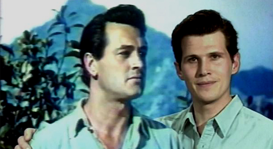 Eric Farr appears to put his arm around Rock Hudson in a vintage film still