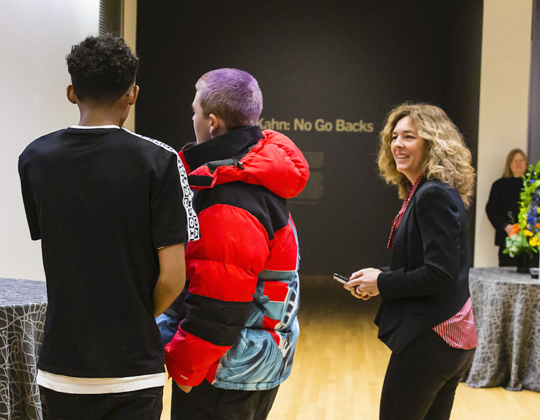 Artist Stanya Kahn looks toward her teenage son and his friend, seen from behind, during the January 31, 2020 opening of Kahn's exhibition No Go Backs at the Wexner Center for the Arts