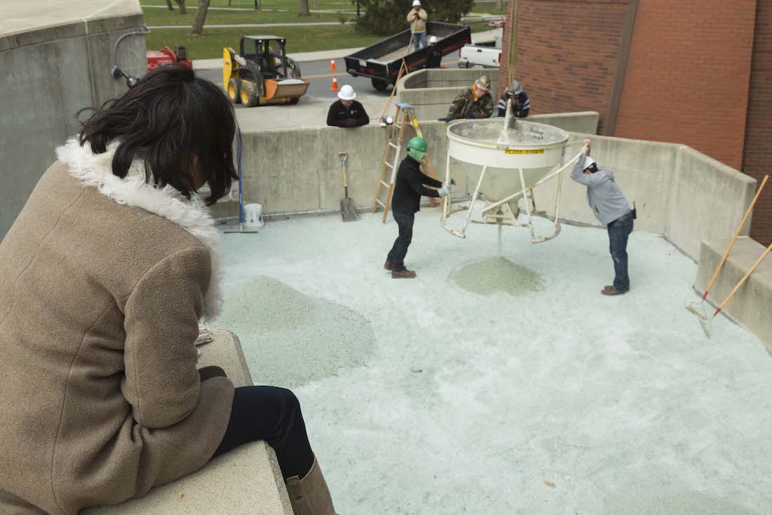 Artist Maya Lin in 2005 overseeing the reinstallation of her work Groundswell at the Wexner Center for the Arts. The work evokes Ohio's ancient Native American burial mounds with its small hills of small safety glass shards