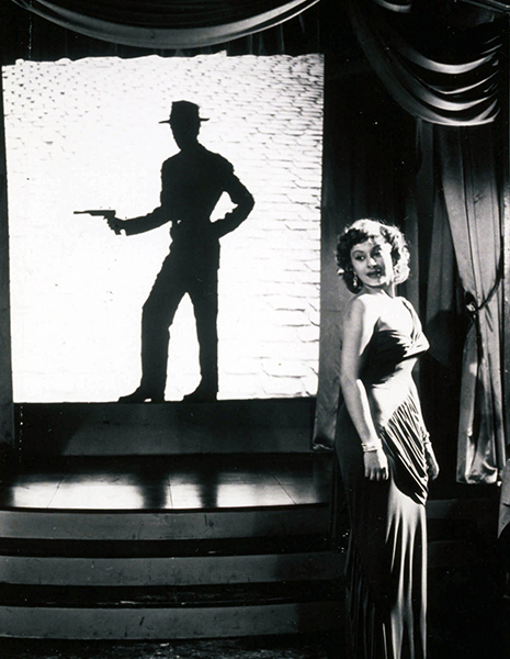 a woman in gown and silhouette of a person with a gun drawn in the background
