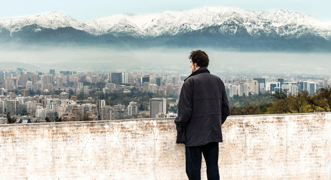 A man looks out over the cityscape in a scene from Nanni Moretti's documentary Santiago, Italia