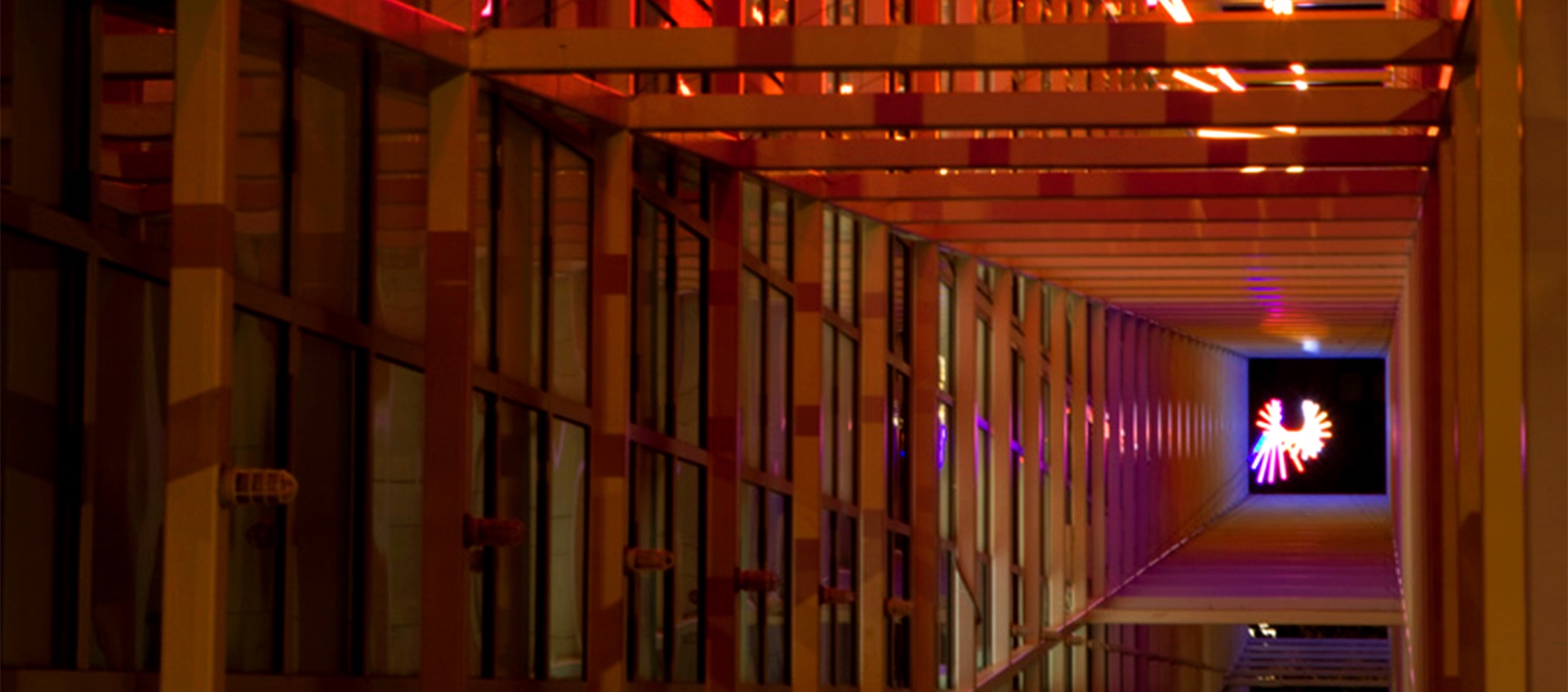 Image of a colorful light installation by artist Erwin Redl in the exterior grid at the Wexner Center for the Arts