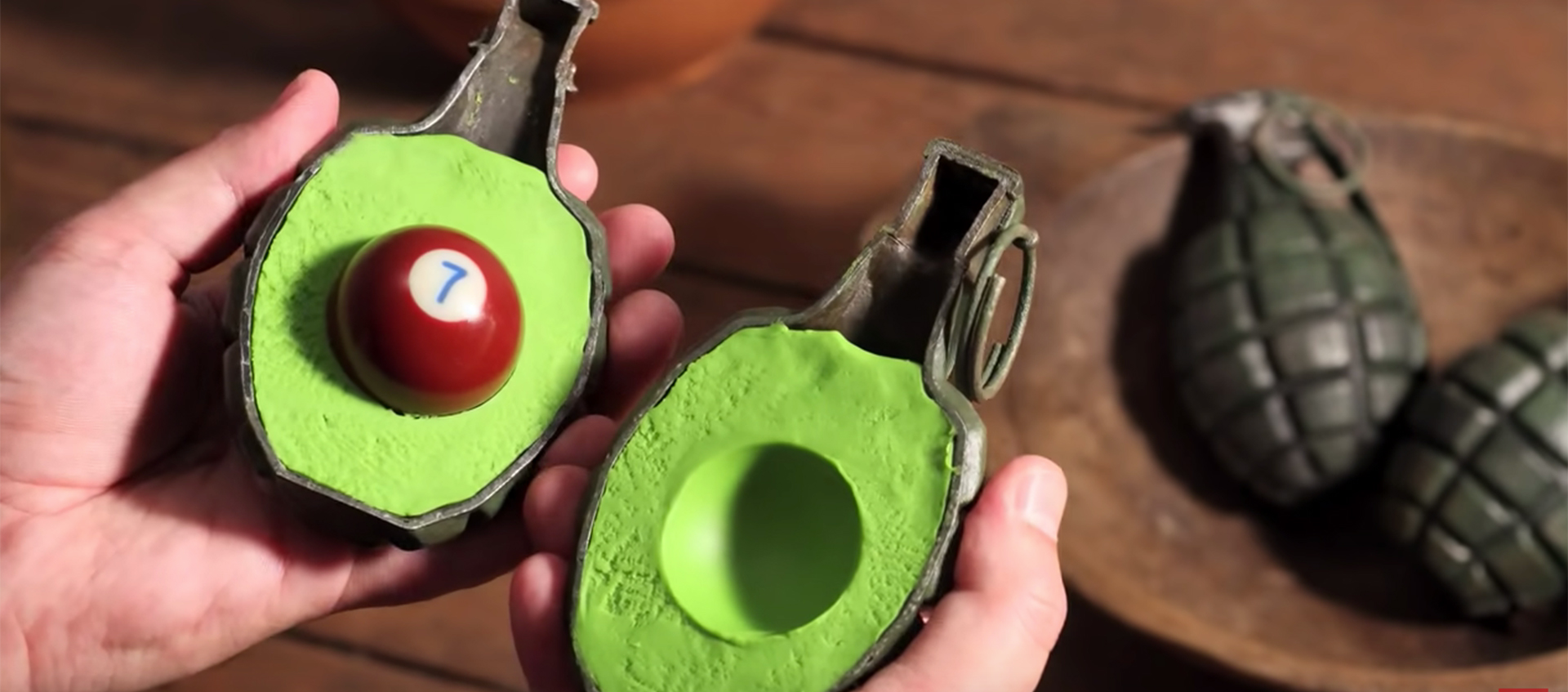 An image of a hand grenade cut in half, filled with green clay and a pool ball to mimic the appearance of a sliced avocado in the stop-motion animated short Fresh Guacamole by PES