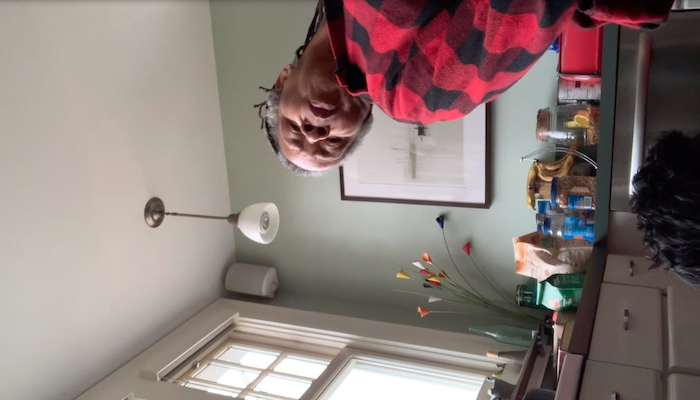 Dancer and choreographer Bebe Miller performs a movement work in her home, captured on a phone attached to her foot, which turns the view of the room sideways
