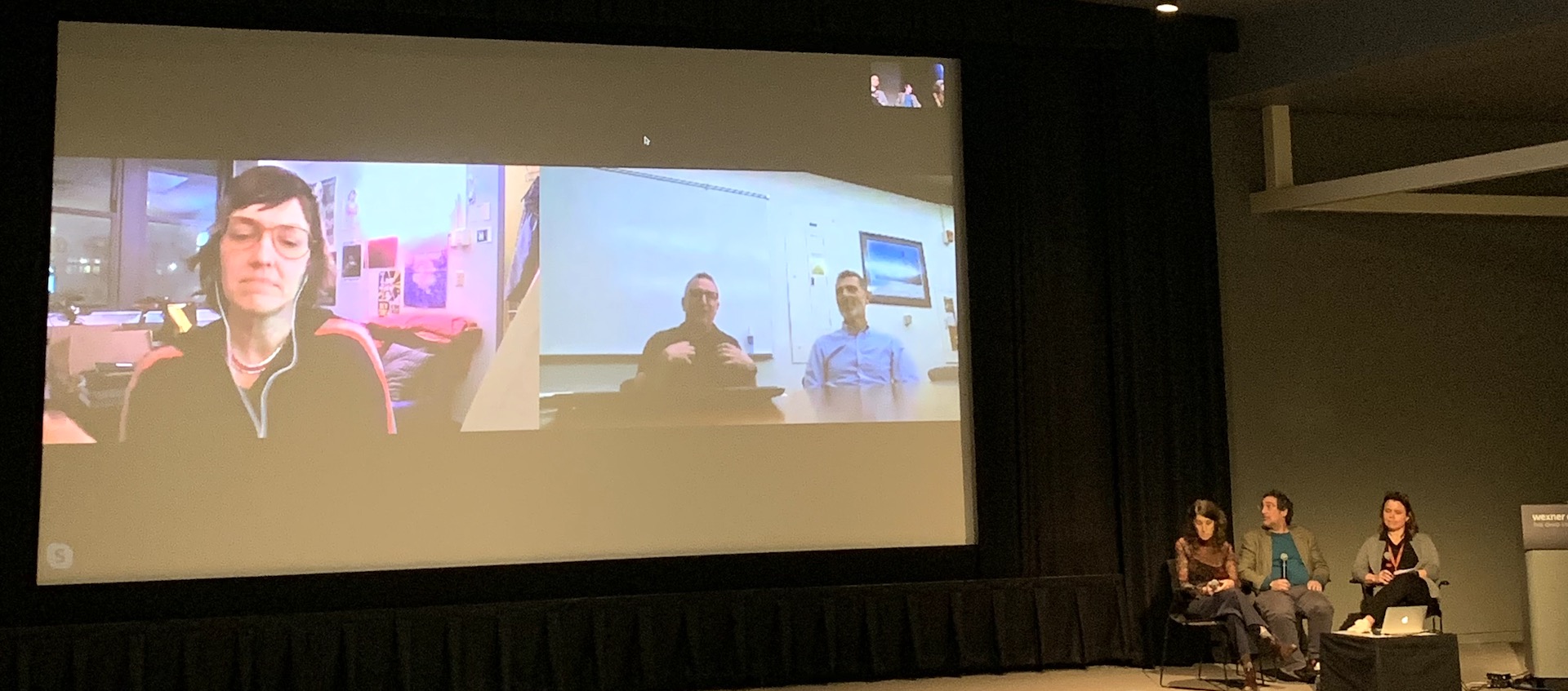 Filmmakers Lynne Sachs and Mark Street and Film/Video Studio Curator Jennifer Lange (L to R, onstage) chat via Skype with filmmakers Deborah Stratman, Dan Veltri, and Frank Lester (on screen) in the Wexner Center Film/Video Theater, November 4, 2019
