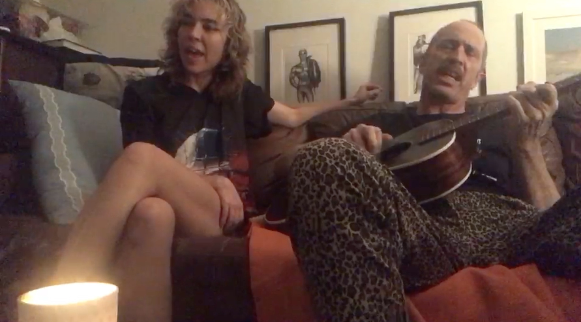 Musicians JR Reynolds and Matt Sweeney singing on their couch