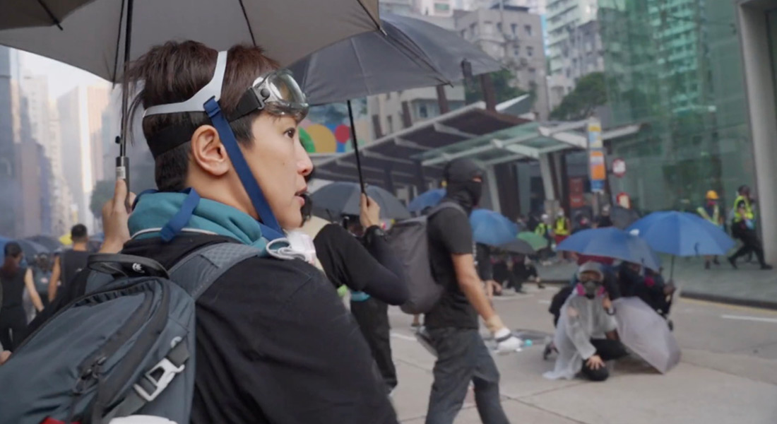 Denise Ho walks under an umbrella during a protest in Hong Kong
