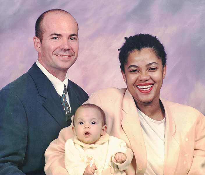 Coleen and Harold Porcher pose with baby Elliot in a family portrait.