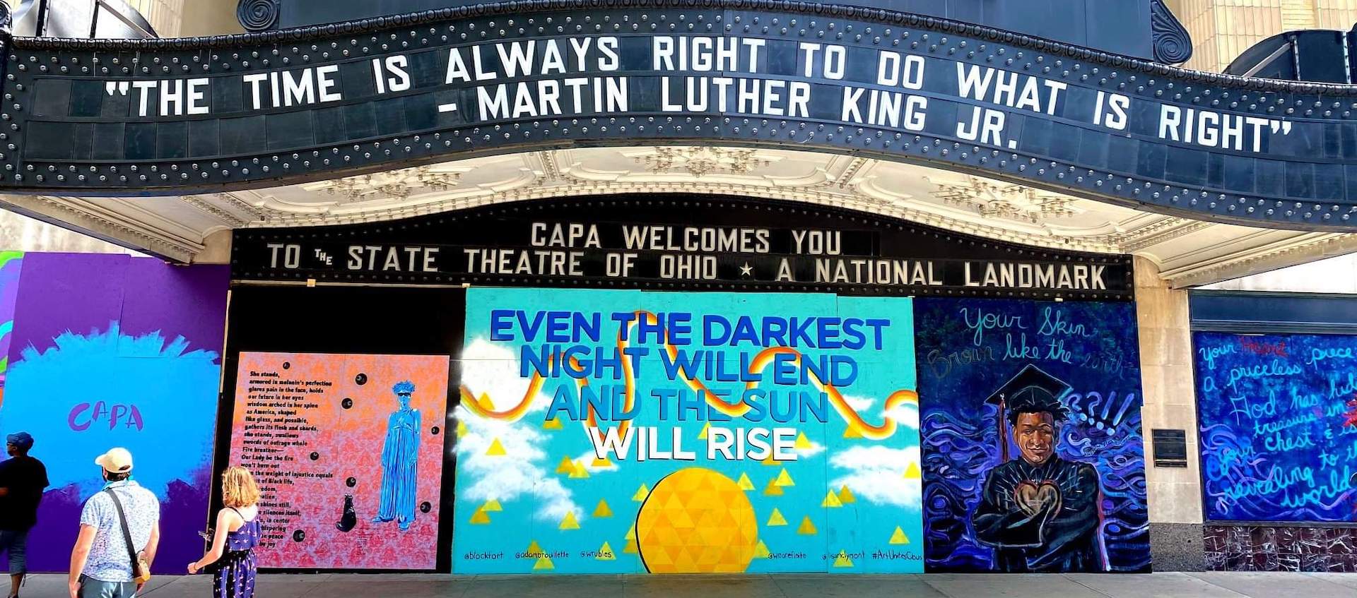 Murals by Columbus Artists covering the boards over the windows of the Ohio Theatre