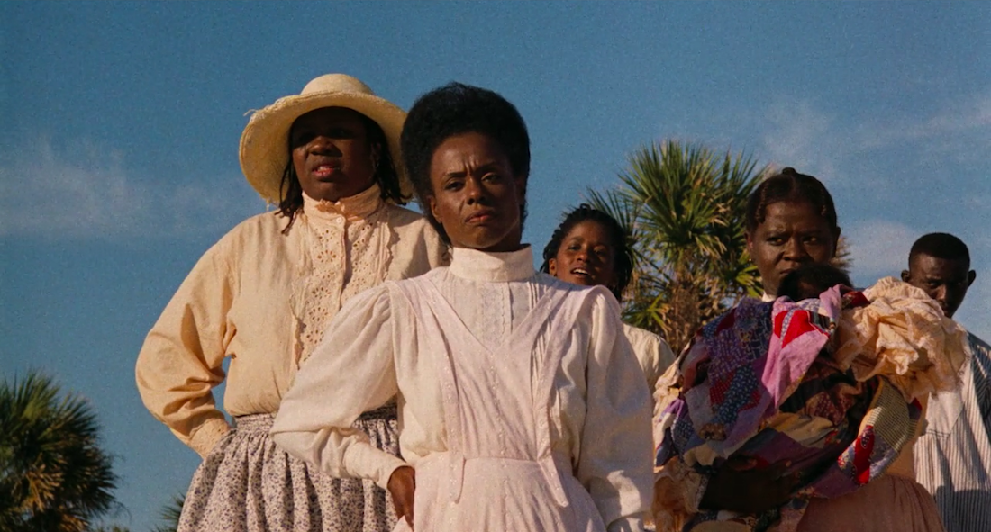 A group of five black women stand together in a scene from Julie Dash's Daughters of the Dust