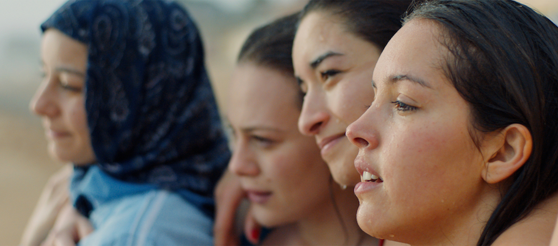 Four young women stand together in a scene from the film Papicha