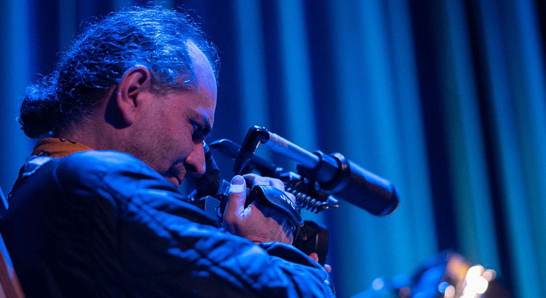 Filmmaker Antonio Ferrera looks through a viewfinder