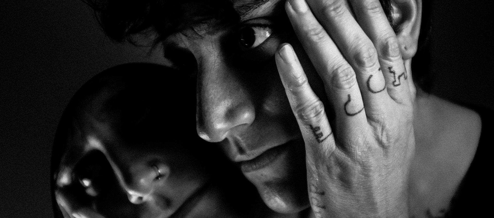 Tight three-quarter profile shot of music artist Moxy Martinez in black and white