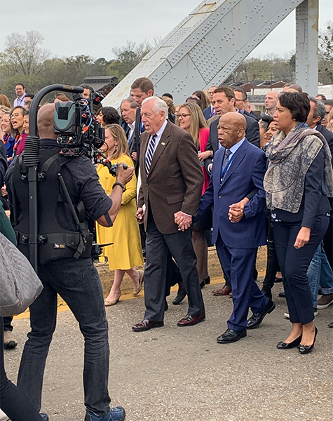 Holding hands with fellow legislators, John Lewis walks on the Edmund Pettus Bridge to commemorate Bloody Sunday (1965) in Selma, Alabama