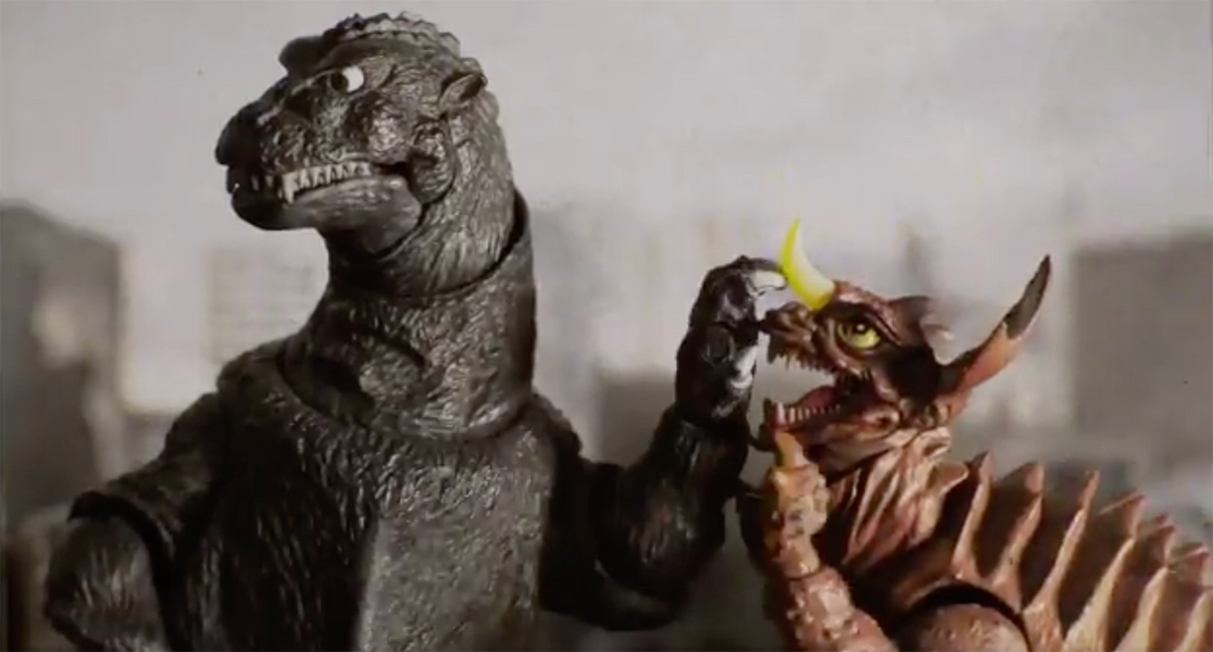 Godzilla pauses a fight in a scene from a stop-motion film by Cressa Maeve Beer