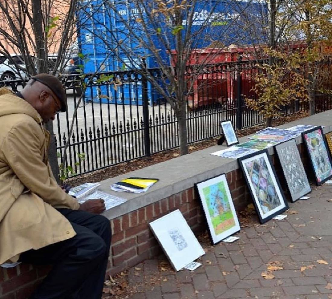 Columbus artist Malcolm J. sells artworks on a sidewalk in the Short North