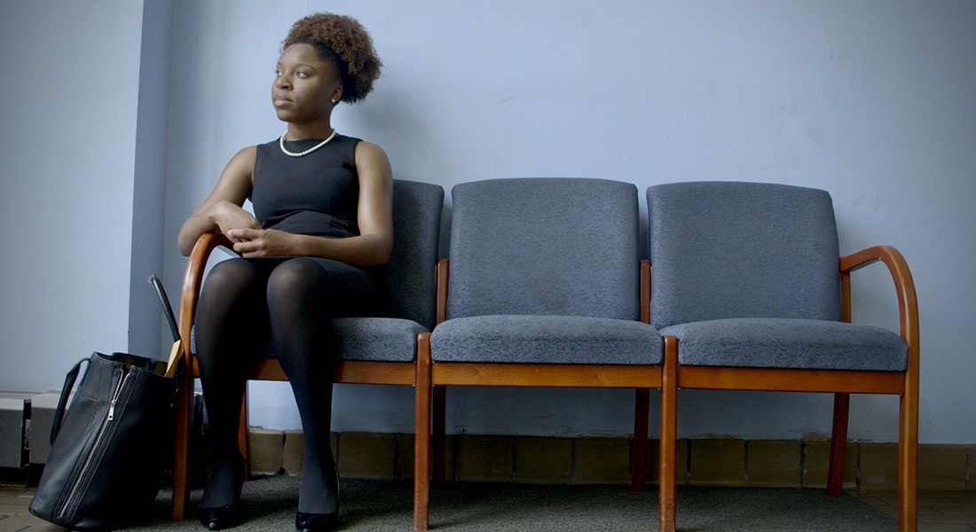 Mayoral candidate Myya Jones sits on a bench in a waiting room