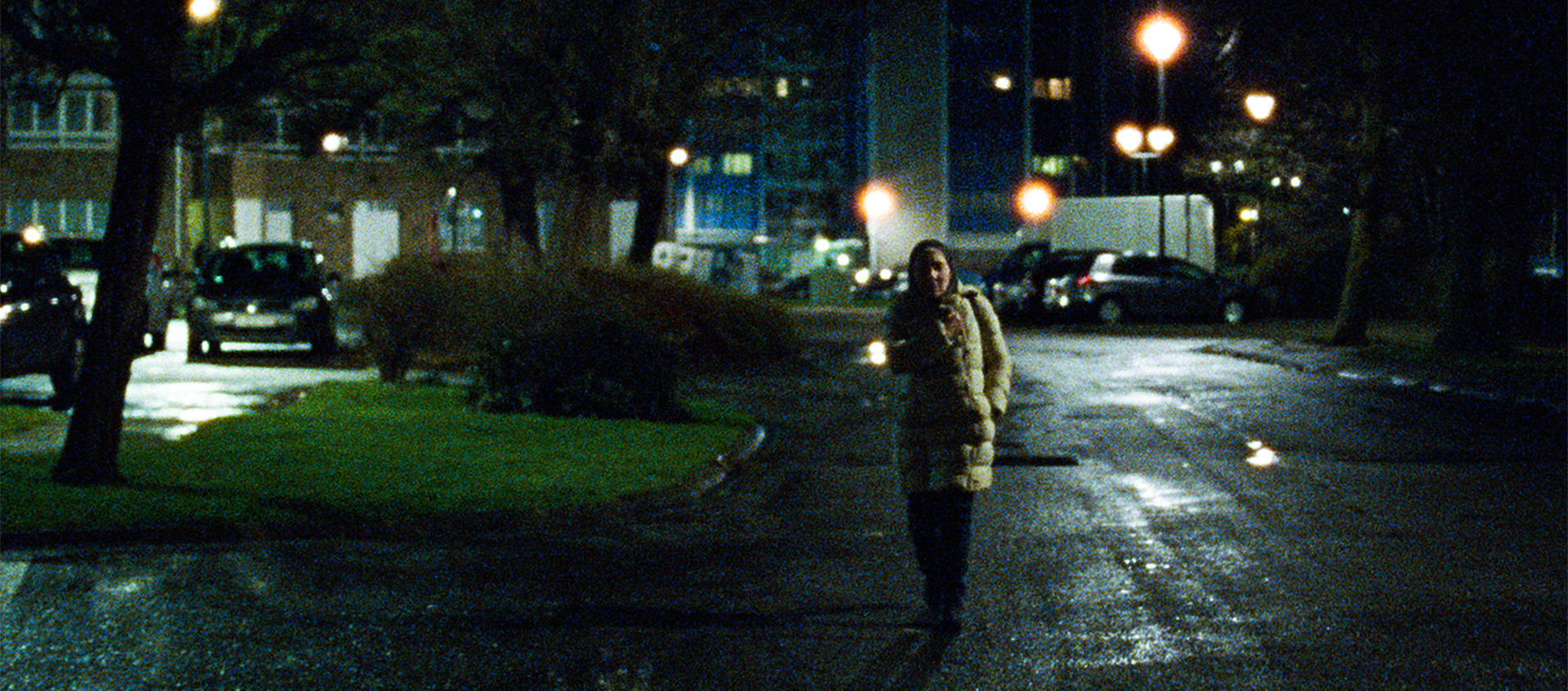 A woman walks alone at night in Brussels in a scene from the film Ghost Tropic