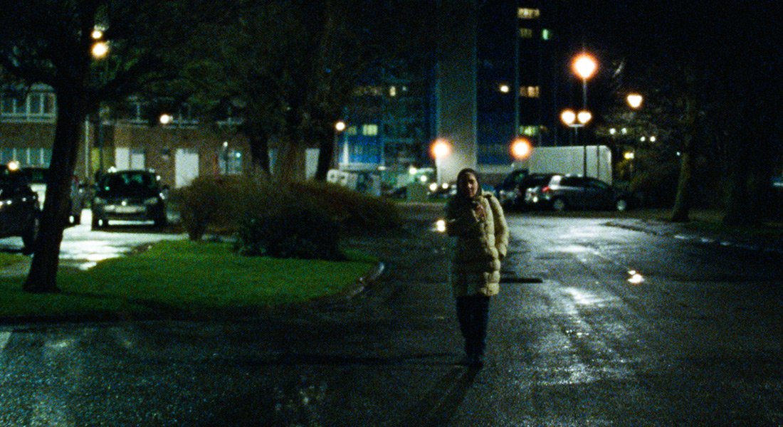 Khadija walks alone in the city at night