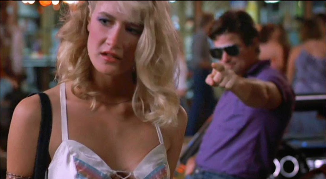 Actress Laura Dern faces the camera as actor Treat Williams points at her in the background in a scene from Smooth Talk