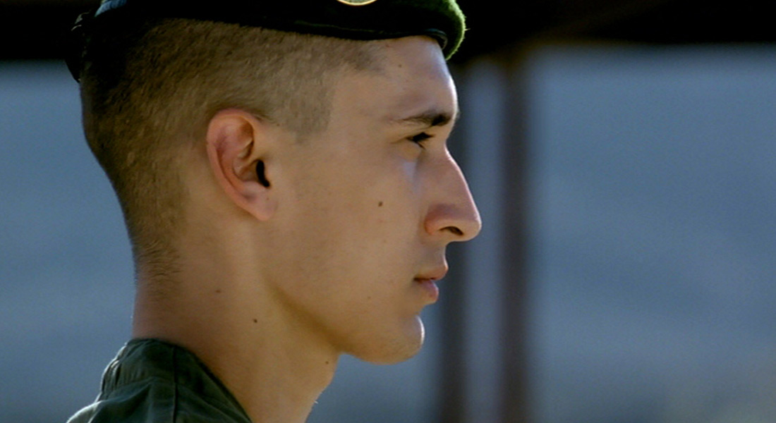 A close-up profile of a soldier in a beret