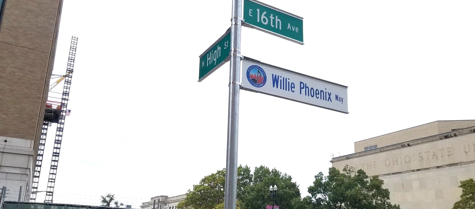 The street signs at the corner of 16th Ave. and High Street in Columbus, Ohio with a new sign added to mark the corner as Willie Phoenix Way