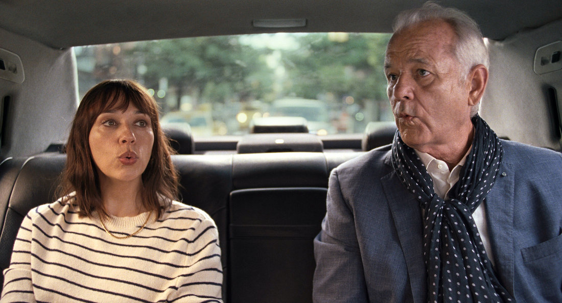 Rashida Jones and Bill Murray sit in the back of a car together in a scene from the Sofia Coppola film On the Rocks