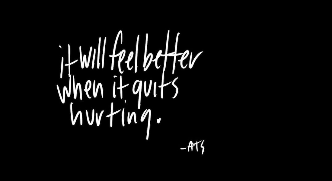 Handwritten white text on a black background by writer Amy Turn Sharp that reads, "it will feel better when it quits hurting."